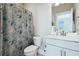Bathroom featuring a single sink, a gray patterned shower curtain, white cabinets, toilet, and chrome hardware at 123 Hewitt St, Summerville, SC 29486