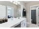 Bathroom featuring a white vanity, large mirror, chrome hardware, black accents, and an adjacent shower and toilet at 123 Hewitt St, Summerville, SC 29486