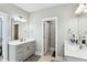 Well-lit bathroom features double vanities, mirrors, and a door leading to additional areas at 123 Hewitt St, Summerville, SC 29486