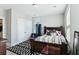 Bedroom featuring a dark wood bed frame, black and white rug, neutral walls, and a closet with folding doors at 123 Hewitt St, Summerville, SC 29486