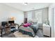 Bedroom features neutral walls, light carpet, two windows, a work desk, and a full-sized bed with patterned pillows at 123 Hewitt St, Summerville, SC 29486