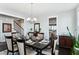 Well-lit dining room featuring a dark wood table and a view into the modern kitchen at 123 Hewitt St, Summerville, SC 29486