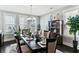 Bright dining room with large windows, elegant chandelier, and dark wood table at 123 Hewitt St, Summerville, SC 29486