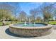 Relax by the lovely brick fountain, a charming community centerpiece, offering a serene escape amidst lush landscaping at 123 Hewitt St, Summerville, SC 29486