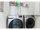 Clean laundry room with front-load washer and dryer and convenient shelving at 123 Hewitt St, Summerville, SC 29486