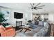 Bright living room with sectional sofa, modern ceiling fan, and open view to kitchen at 123 Hewitt St, Summerville, SC 29486