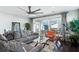 Comfortable living room features a large sectional sofa, ceiling fan, and sliding glass doors to the outdoor space at 123 Hewitt St, Summerville, SC 29486