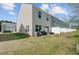 Spacious backyard featuring lawn area, patio with furniture, grill, and a white privacy fence at 124 Gaura Ln, Summerville, SC 29483