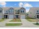 Charming townhome with neat lawn, tidy landscaping, garage, and appealing architectural details at 124 Gaura Ln, Summerville, SC 29483
