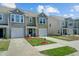 Exterior view of attractive townhomes with attached garages, well-kept lawns and landscaping at 124 Gaura Ln, Summerville, SC 29483