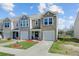 Lovely townhomes with attached garages, manicured lawns, and pleasant landscaping at 124 Gaura Ln, Summerville, SC 29483