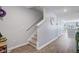 Hallway with a staircase, wall clock, and access to kitchen at 124 Gaura Ln, Summerville, SC 29483