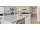 Kitchen island view with stainless steel sink, faucet and a living area in the background at 124 Gaura Ln, Summerville, SC 29483
