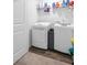 Bright laundry room with white washer and dryer, shelving unit at 124 Gaura Ln, Summerville, SC 29483