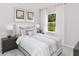 Cozy bedroom featuring a comfortable bed, a window with curtains, and neutral decor at 133 Royal Cainhoy Way, Huger, SC 29450