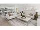 Elegant living room and kitchen featuring stylish sofas, a coffee table, and modern appliances at 133 Royal Cainhoy Way, Huger, SC 29450