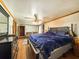 A Primary bedroom with a large bed, wood floors, and closet with a dresser at 1393 Russellville Rd, Saint Stephen, SC 29479