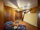 A bedroom with wood-paneled walls, a folding screen, and vinyl flooring at 1393 Russellville Rd, Saint Stephen, SC 29479
