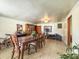 Spacious dining room with a large wooden table, tiled floors, and ample space for exercise equipment at 1393 Russellville Rd, Saint Stephen, SC 29479