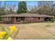 Charming brick home with a carport, complemented by mature trees and a spacious front yard at 1393 Russellville Rd, Saint Stephen, SC 29479