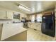 Well-lit kitchen with laminate floors, modern appliances, and ample cabinet space for storage at 1393 Russellville Rd, Saint Stephen, SC 29479