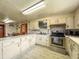 Spacious kitchen with laminate floors, ample counter space, and stainless steel appliances for modern convenience at 1393 Russellville Rd, Saint Stephen, SC 29479