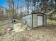 This shows a backyard with a metal shed and a small dog house in the distance at 1393 Russellville Rd, Saint Stephen, SC 29479