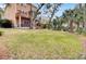 Expansive backyard features mature palm trees, a deck, a hot tub, and plenty of green space at 1428 Bloomingdale Ln, Mount Pleasant, SC 29466
