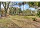 Spacious backyard featuring palm trees, shrubs, and a scenic view of the marsh at 1428 Bloomingdale Ln, Mount Pleasant, SC 29466