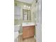 This bathroom has a white sink, a matching vanity, mirror and light fixture at 1428 Bloomingdale Ln, Mount Pleasant, SC 29466
