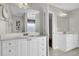 Spacious bathroom features a double vanity, tile floors, and an adjacent room with a bathtub and shower at 1428 Bloomingdale Ln, Mount Pleasant, SC 29466