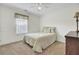 Bright bedroom with ceiling fan, carpeted floor, and a comfortable bed with floral patterned bedding at 1428 Bloomingdale Ln, Mount Pleasant, SC 29466