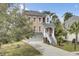 Elegant two-story home with well-maintained landscaping and an inviting staircase leading to the front door at 1428 Bloomingdale Ln, Mount Pleasant, SC 29466
