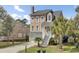 Beautiful two-story home showcasing a well-manicured lawn and a charming entrance with a white picket fence at 1428 Bloomingdale Ln, Mount Pleasant, SC 29466