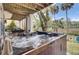 Outdoor hot tub surrounded by nature with patio chairs and access to outdoor green space at 1428 Bloomingdale Ln, Mount Pleasant, SC 29466