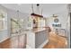 Spacious kitchen with granite island seamlessly transitioning into a cozy living room at 1428 Bloomingdale Ln, Mount Pleasant, SC 29466