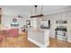 Open kitchen and living area with stainless appliances, granite island, and hardwood flooring at 1428 Bloomingdale Ln, Mount Pleasant, SC 29466
