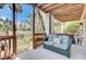 This patio has a love seat and an open view of the yard beyond the wooden railing at 1428 Bloomingdale Ln, Mount Pleasant, SC 29466