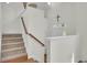 Stairway with carpet and wooden banister leading to front door at 1428 Bloomingdale Ln, Mount Pleasant, SC 29466