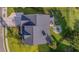 An aerial view of a landscaped home featuring a backyard with patio, firepit, and lush green grass at 144 Back Tee Cir, Summerville, SC 29485