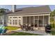 Spacious backyard featuring a screened porch, patio, and lush lawn perfect for outdoor living and entertainment at 144 Back Tee Cir, Summerville, SC 29485