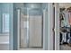 Bright bathroom featuring glass enclosed shower and walk-in closet for storage at 144 Back Tee Cir, Summerville, SC 29485