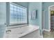 Clean white bathtub with textured glass window in updated bathroom design at 144 Back Tee Cir, Summerville, SC 29485