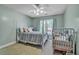 Inviting bedroom featuring a cozy bed, a crib, and a window with natural light at 144 Back Tee Cir, Summerville, SC 29485