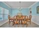 Traditional dining room boasts elegant wainscoting, stylish lighting, and wood-look tile floors at 144 Back Tee Cir, Summerville, SC 29485