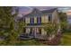 Charming two-story home featuring a welcoming front porch with rocking chairs and well-manicured lawn at 144 Back Tee Cir, Summerville, SC 29485