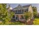 Charming two-story home featuring a welcoming front porch with rocking chairs and well-manicured lawn at 144 Back Tee Cir, Summerville, SC 29485