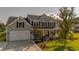 Charming two-story home featuring a welcoming front porch and well-manicured lawn and a two car garage at 144 Back Tee Cir, Summerville, SC 29485