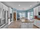 Kitchen with white cabinets, stainless appliances, an island, and an eat-in kitchen area at 144 Back Tee Cir, Summerville, SC 29485