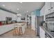 Bright kitchen with white cabinets, stainless appliances, and an island with bar stool seating at 144 Back Tee Cir, Summerville, SC 29485